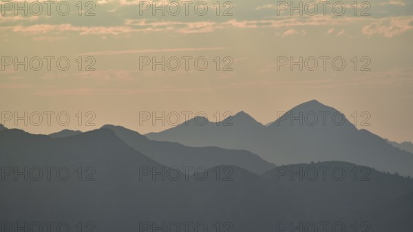 Silhouette of the Sonntagshorn, highest mountain of the Chiemgau Alps, in the backlight, Bavaria,