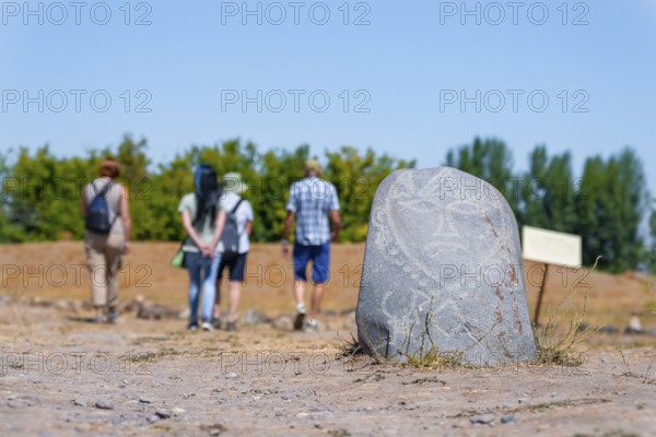 Tourists, Balbals, historical gravestones in the shape of human faces, near Tokmok, Chuy,