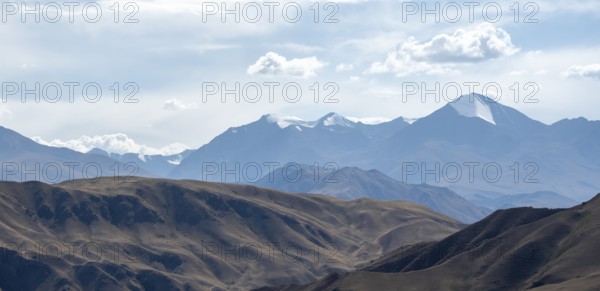 View over eroded mountainous landscape with brown hills, mountains and steppe, Chuy province,