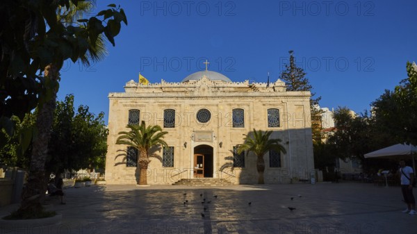 Agios Titos Church, facade, forecourt, palm trees, blue cloudless sky, city centre, old town,