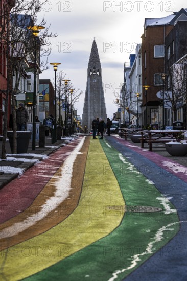 Shopping street Skolavördustigur, painted in the colours of the rainbow, lightly covered with snow,