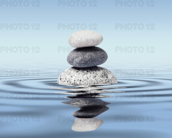 Zen stones in water with reflection, peace balance meditation relaxation concept