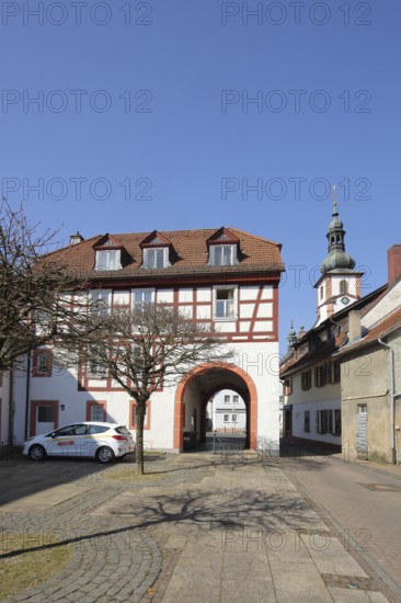 Historic Schleifrashaus, Schleifrashof and church tower, half-timbered house, Salmünster, Bad