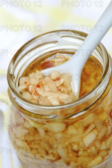 Aglio e Olio, pasta sauce from garlic, olive oil, and peperoncino in glass, chillies, Mediterranean