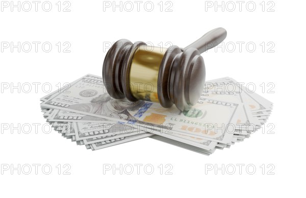 Gavel resting on stacks of thousands of dollars isolated on a white background