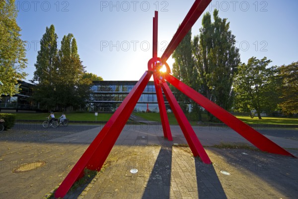Bright red sculpture made of steel profiles L'Allumé by Mark di Suvero in front of the Bundeshaus
