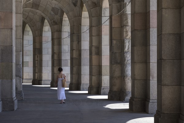 Lady in a white dress in the arcade of the Congress Hall, unfinished National Socialist monumental