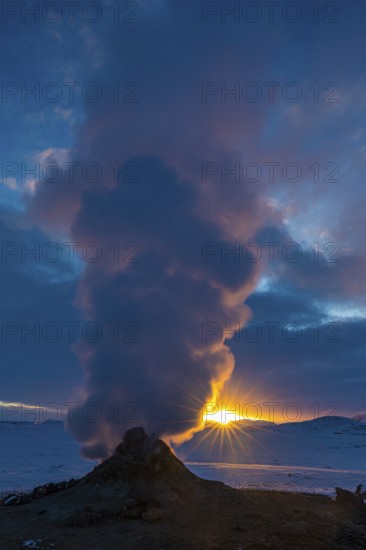 Mud pot with steam source at sunrise, Hverir solfataras field, fumaroles, snow-covered geothermal