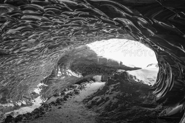 Filigree ice honeycombs at the entrance to the Pröng ice cave, black and white photo, Sudurland,