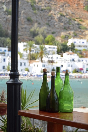 Empty green bottles as decoration, view of Loutro, South Crete, Crete, Greece, Europe
