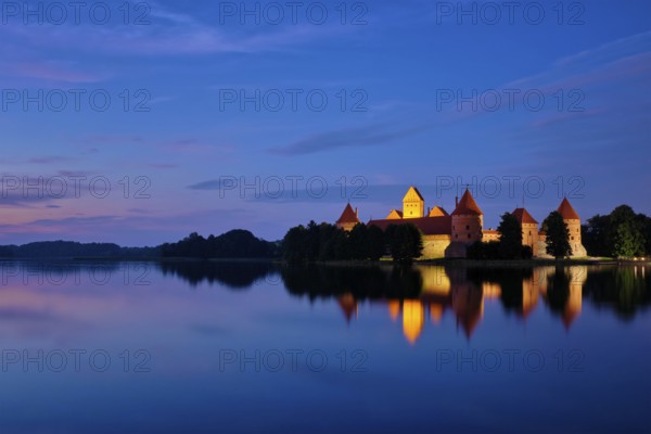 Evening view of Trakai Island Castle in lake Galve illuminated in the night reflecting in peaceful
