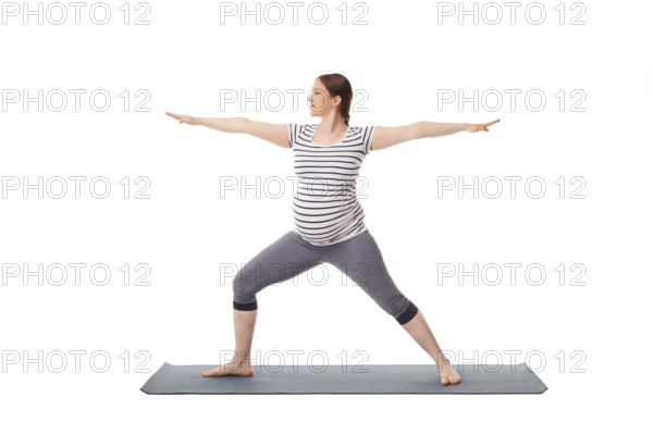 Pregnancy yoga exercise, pregnant woman doing asana virabhadrasana 2, warrior pose isolated on