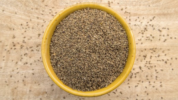 Carom Seeds, Thymol Seeds, Bishop's Weed, Ajwain in a Yellow Bowl, Flat Lay