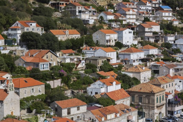 High angle view of tan and white trim houses and villas with traditional terracotta clay tile