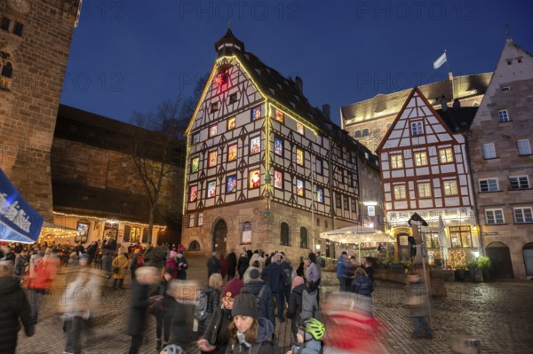 Historic Pilkatushaus with an Advent calendar on 18 December 2024 at dusk, behind the Imperial