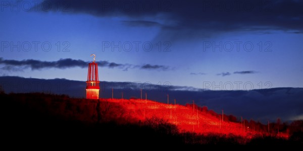 Artwork Illuminated at night with red illuminated slagheap Rheinpreussen by Otto Piene, Moers, Ruhr