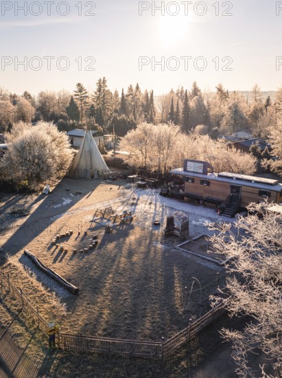 Tipi and caravan in a frosty winter landscape with rays of sunshine, day care centre, Gechingen,