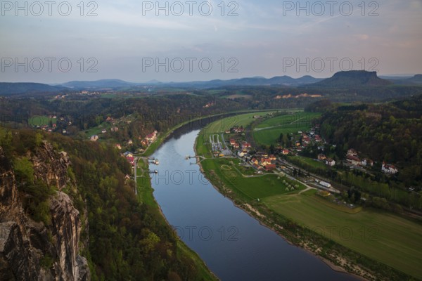 Elbe river at dawn seen from the Bastei rocks near the village of Rathen in Saxon Switzerland