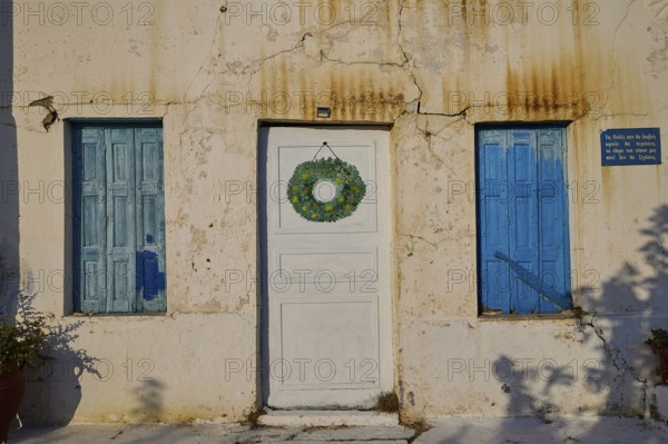 Detail of a house with blue shutters and decorated white door, Pyles village, west coast,