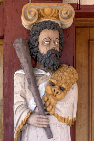 Atlant, figure of the god Hercules, colourfully painted carving on the portal to the town hall,