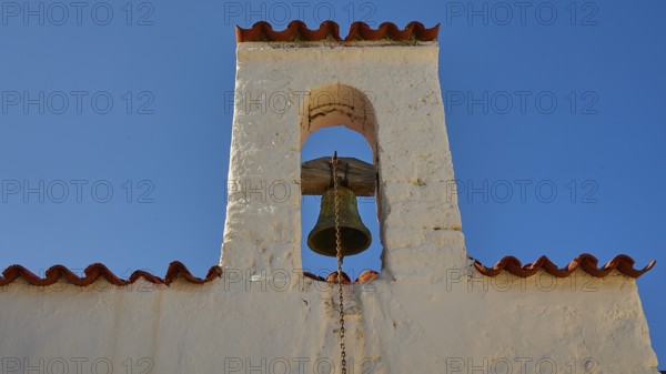 Close-up of a bell tower with a bell under a blue sky, Agios Ioannis church, Mesochori village,