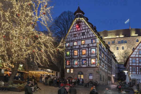 Historic Pilatus House with an Advent calendar designed by the Altstadtfreuden Nuremberg, behind