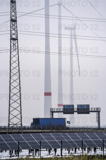 Wind farm in the fog, photovoltaic system, on the A44 motorway, dark doldrums, no wind no direct