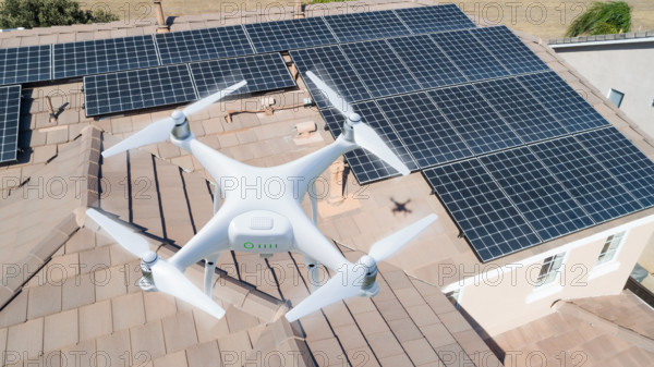 UAV drone inspecting solar panels on large house