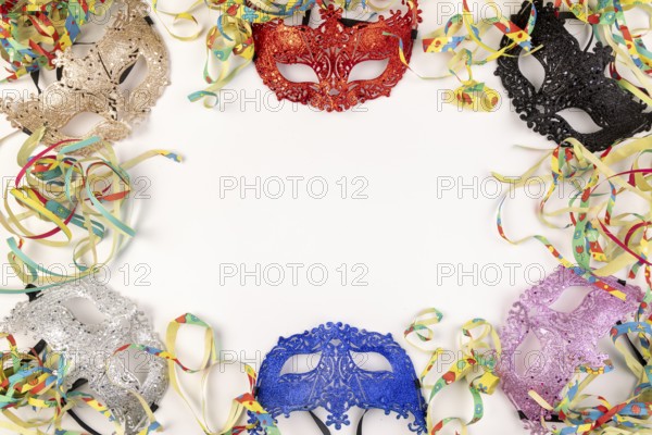 Colourful masks and paper snakes on a white background, carnival atmosphere
