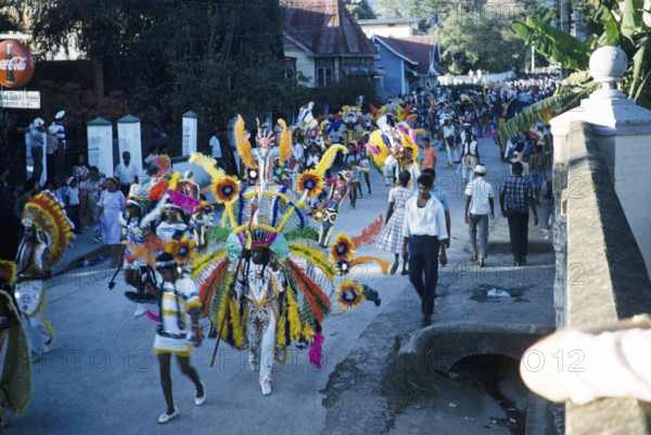 People in colourful costumes at the carnival parade, Port of Spain, Trinidad 1963 with the title