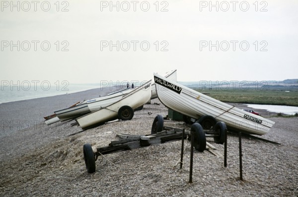 Fishing spots on the shingle ridge on the beach at Cley, Norfolk, England, UK undated ca. 1970s