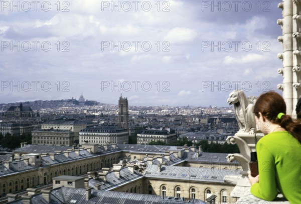 People looking at the city from Notre Dame Cathedral, Notre Dame, Paris, France, 1970, Europe