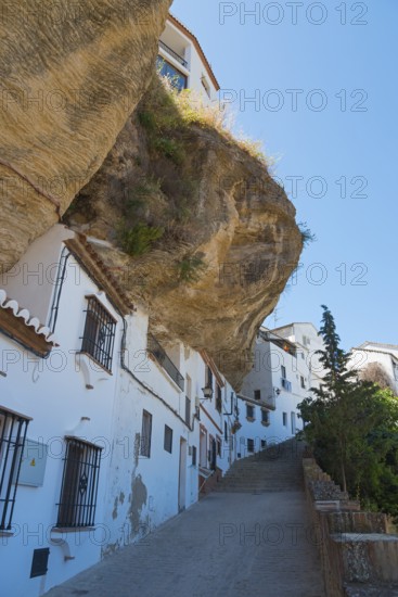 Street in Setenil de las Bodegas with overhanging rock, sunny, cave dwellings, Setenil de las
