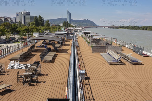Lounge deck on the riverbank with a view of the city, Vienna
