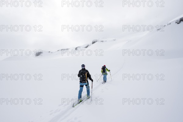 Ski tourer in the fog on the glacier Glacier de la Plaine Morte, mountain landscape with snow,
