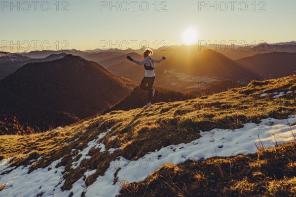 Trail running in autumn on the Jochberg on Lake Walchensee against the wonderful backdrop of the