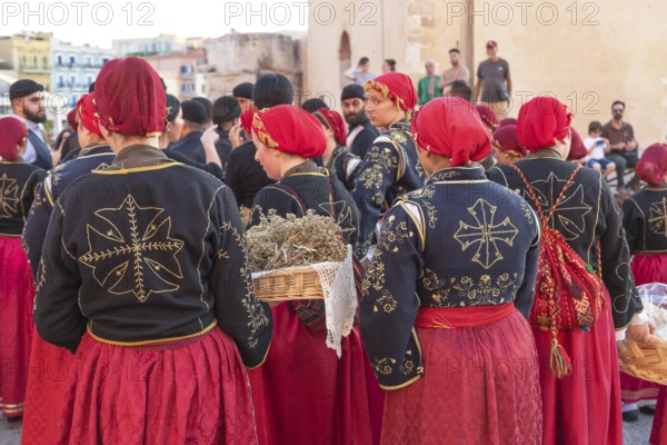 Traditionally dressed Greek women carrying gifts during marriage celebration, Chania, Crete, Greek