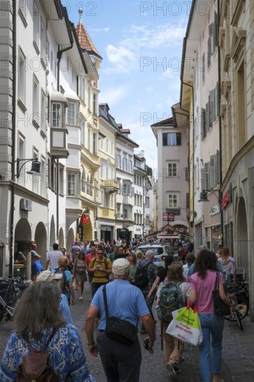 Bolzano, South Tyrol, Italy, Passers-by stroll through the Laubengasse in the old town centre,