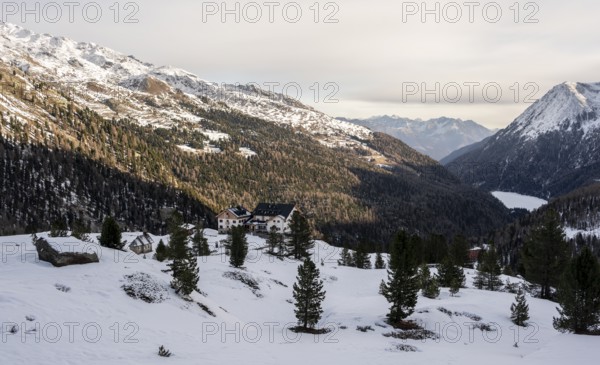 Zufallhütte mountain hut, view of the Martell Valley, snow-covered mountain landscape in winter,
