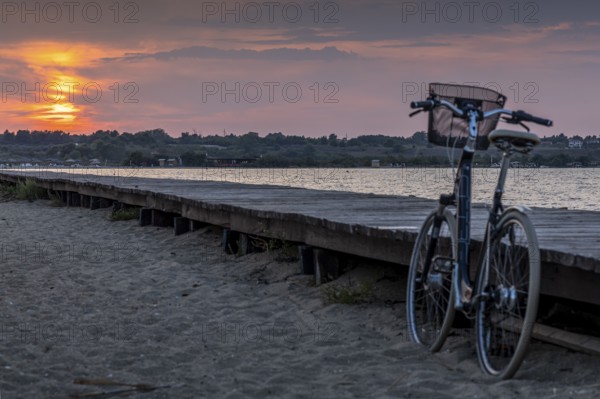 Bicycle at the jetty with orange sunset at the sea, calm evening mood, Nin, Zadar, Croatia, Europe