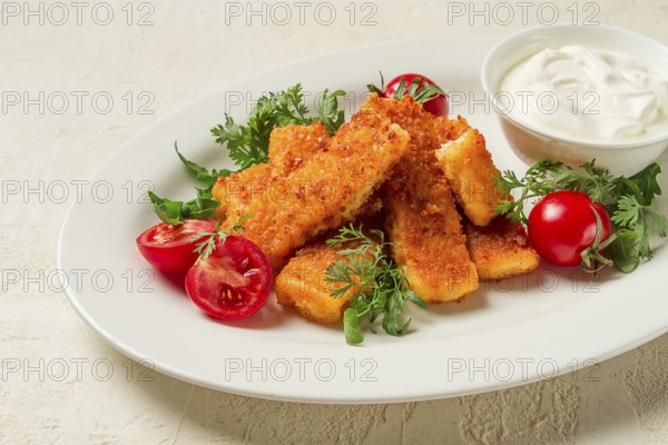Fried fish nuggets, with white sauce, arugula and cherry, no people