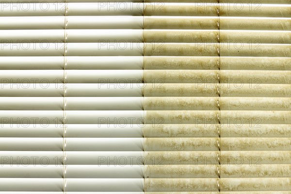 Residential window shades showing the before and after of a good cleaning, one side clean and one