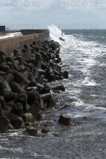 Storm on the offshore island of Heligoland, waves lashing against the western breakwater, tetrapods