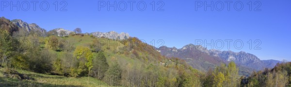 Autumn colours with a view towards the mountain range with Refugio Achille Papa, Piccolo Dolomiti,