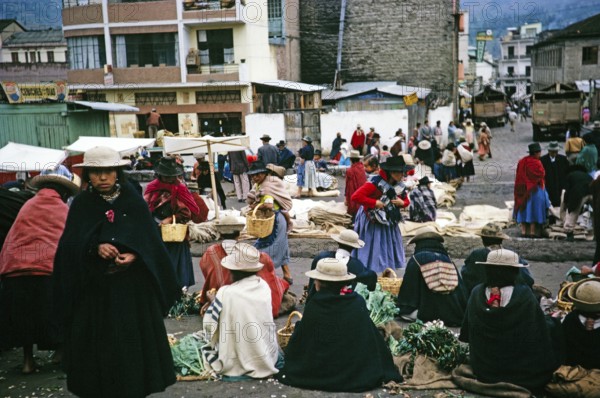 Indigenous market traders on the street, Ambato market, Ecuador, South America, 1962, South America