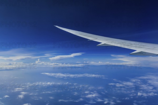 View from the aircraft window during a flight over India with the airline Etihad. Blue sky and