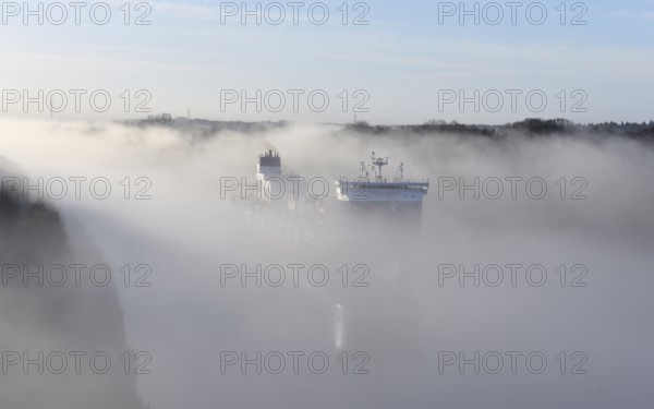 Container ship CMA CGM TIVOLI sailing in fog in the Kiel Canal, NOK, Kielkanal, Kiel Canal,