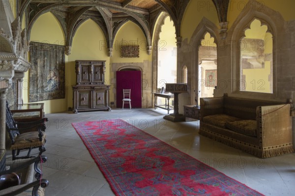 Furniture and wall tapestries in the Morning Room inside Berkeley castle, Gloucestershire, England,