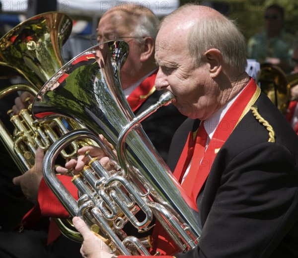 Musicians in a brass band perform during a country fair at Helmingham Hall, Suffolk, England,