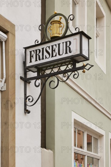 Historical sign for a hairdresser on a house in Warendorf, district of Warendorf, North